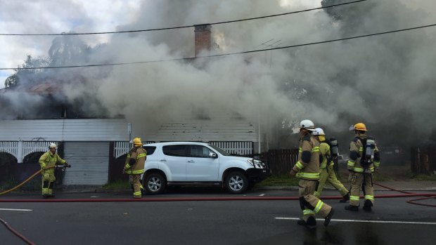 Firefighters battle a house fire in Auchenflower.