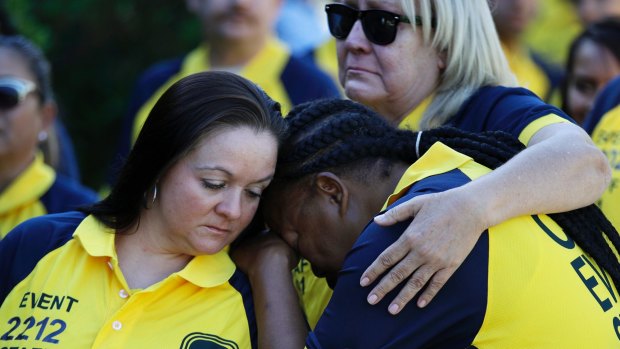 Kim Bartlett, left, comforts Cassandra Johnson before a funeral for their coworker who was killed in the Las Vegas shooting.