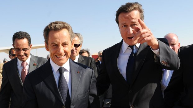 Former British PM David Cameron, right, and former French President Nicolas Sarkozy arrive in Benghazi, Libya, in 2011.