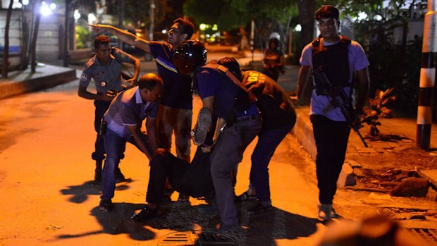 An injured man receives help after an attack at a Dhaka restaurant.