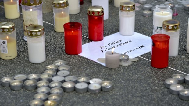 Candles outside the Josef-Koenig-Gymnasium high school in Haltern am See.