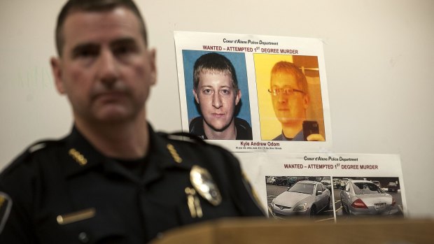 Coeur d'Alene Police Chief Lee White speaks during a news conference on Monday with a photo of Kyle Andrew Odom in the background.