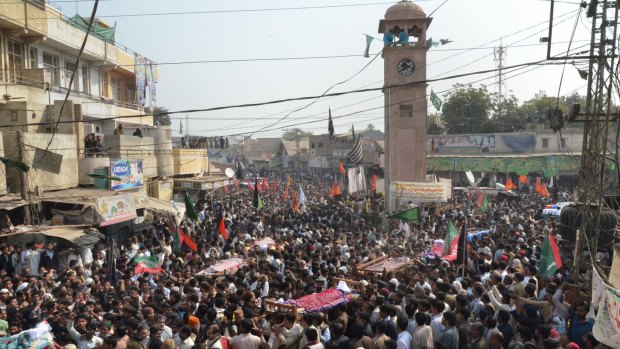 Mourners carry the coffins of the blast victims through the streets of Shikarpur.