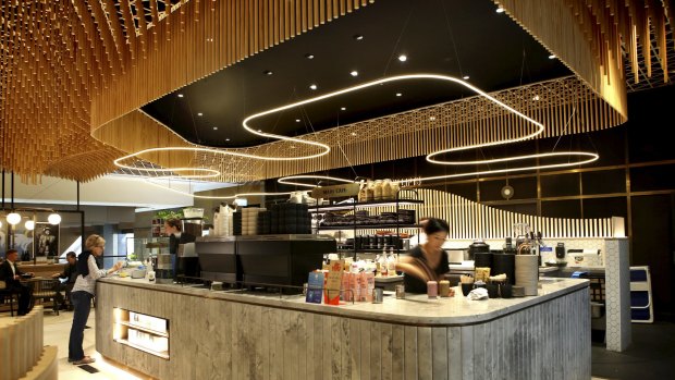Portal Cafe features timber waves of wooden rods that swoop from the ceiling.
