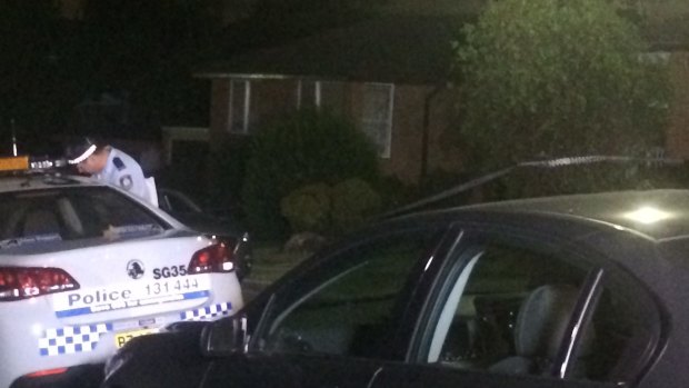 Police in front of the Bexley home where a woman was stabbed to death and her daughter was injured.