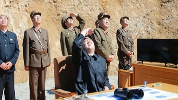 A video of a news bulletin aired by North Korea's KRT on Tuesday shows what was said to be North Korea leader Kim Jong-un (centre) watching the launch.