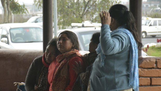 Relatives break down while waiting for information about the accident at Pokhara Domestic Airport.