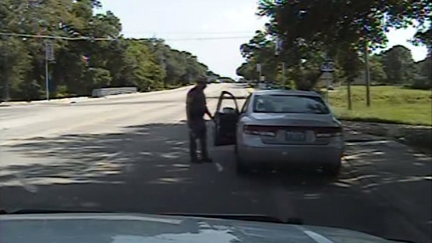 The officer opens the driver's side door as he orders Sandra Bland out of her vehicle, in this still image from the police dash camera video that recorded the traffic stop.