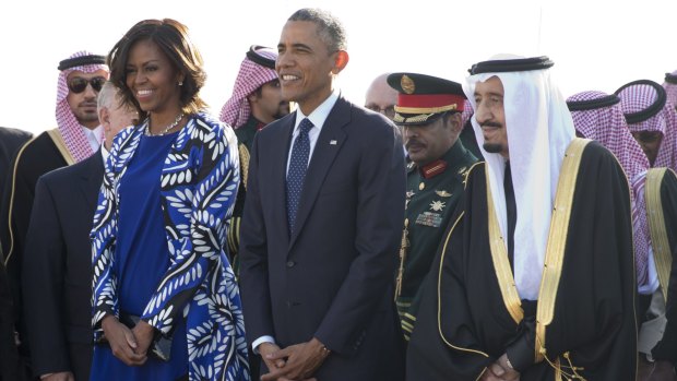 President Barack Obama and first lady Michelle Obama stand with new Saudi King Salman bin Abdul Aziz at Riyadh airport.