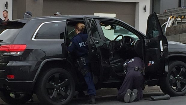 Police search a car during a raid on a house in Lockwood Street, Merrylands, in Sydney's west on Wednesday.

 