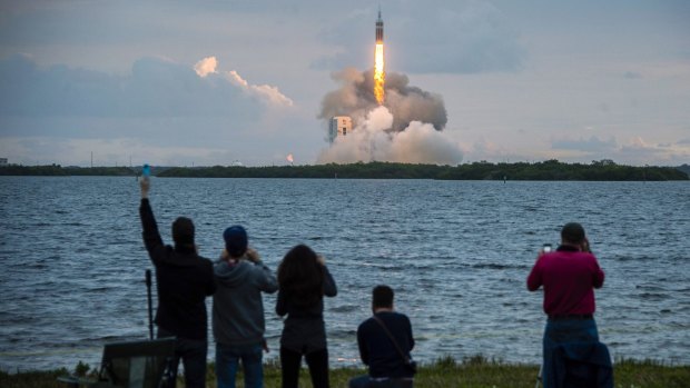 Blast off: Spectators cheer the launch of NASA's Orion spacecraft. 