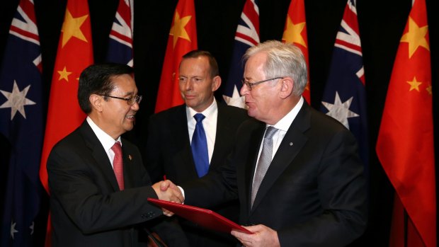 Chinese Commerce Minister Gao Hucheng, former prime minister Tony Abbott and then trade minister Andrew Robb at the signing of the China-Australia free trade agreement in June 2015. 