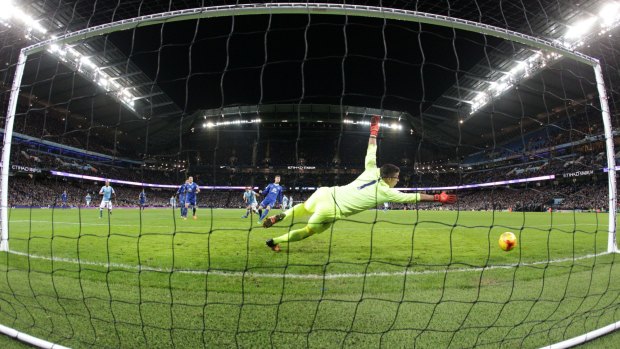Manchester City's Sergio Aguero (left) scores his side's third goal past Everton's goalkeeper Joel Robles.