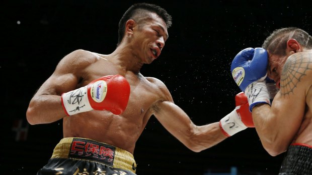 Japanese champion Takashi Uchiyama, left, proved too strong for Argentine challenger Israel Perez in their WBA super featherweight boxing title bout in Tokyo.