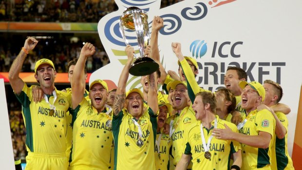 Australian captain Michael Clarke holds the trophy aloft with his teammates as they celebrate their seven-wicket win over New Zealand in the Cricket World Cup final in Melbourne on Sunday.