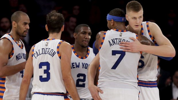 Respect: New York Knicks forward Carmelo Anthony hugs rookie Kristaps Porzingis as they huddle with Arron Afflalo, Jose Calderon and Langston Galloway.