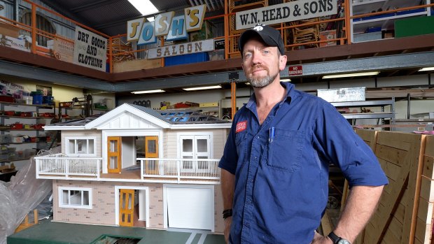 Adam Head with the modified dollhouse he constructed for a Queensland government ad on safety switches.
