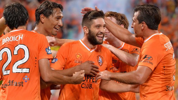 Brandon Borrello of the Roar celebrates with team mates after scoring a goal against the Phoenix.  