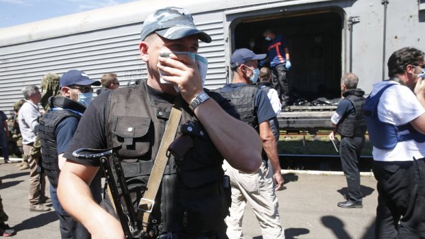 Pro-Russian rebels guard the train carrying bodies of MH17 victims.