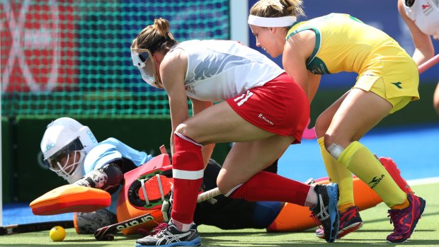Australia's Ashleigh Nelson (right) has a shot at goal go past England's Kate Richardson-Walsh (centre) only to be blocked by goalkeeper Maddie Hinch.