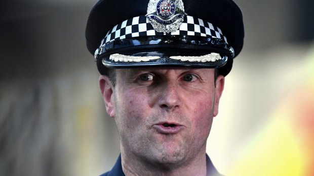 Commander Russell Barrett during a press conference at the scene.