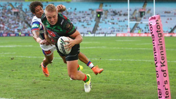 Flying to the line: Aaron Gray fends away from Dane Gagai to score.