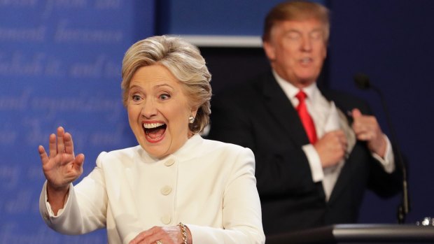 Hillary Clinton waves as Donald Trump puts away his notes at the third presidential debate.