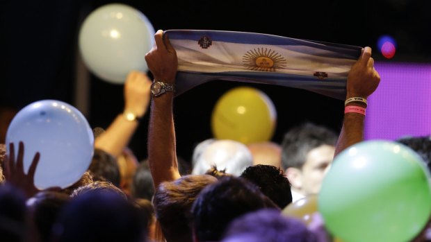 Supporters of opposition presidential candidate Mauricio Macri celebrate preliminary results  in Buenos Aires on Sunday.