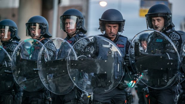 Police in riot gear prepare to deal with violent clashes between protesters outside the Milo Yiannopoulos event in Kensington on Monday.