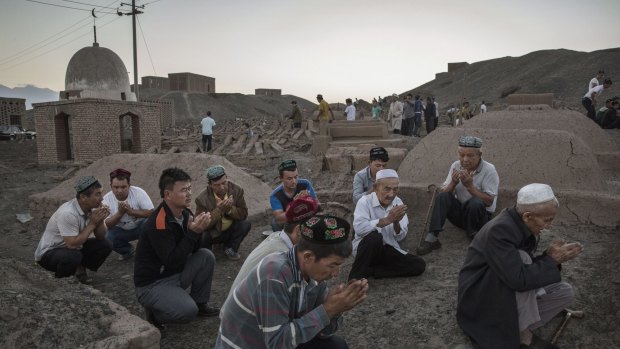 Uighur men perform prayers for the Islamic festival of Eid al-Adha in Turpan County, Xinjiang, in September.