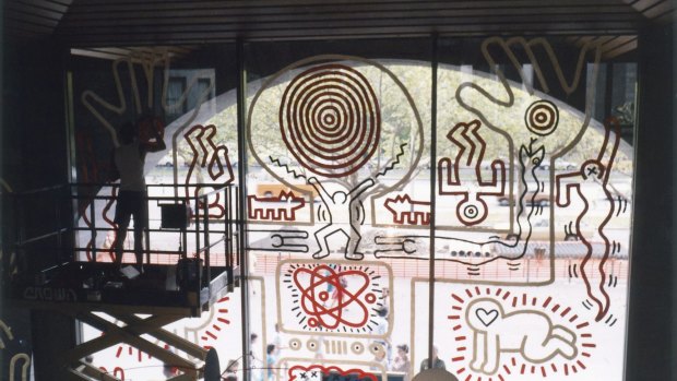 Keith Haring works on his water wall mural during his visit to the National Gallery of Victoria.