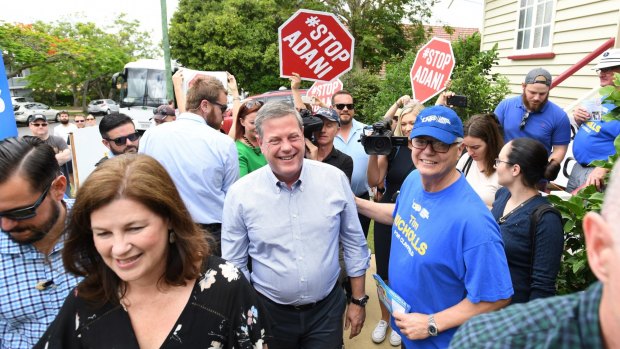 Queensland LNP leader Tim Nicholls was surrounded by anti-Adani protesters as he arrived to vote in his electorate on Saturday.