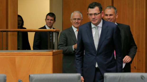 Daniel Andrews emerges to face the press alongside other state and federal leaders.