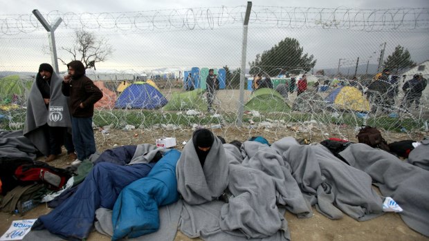 Refugees and migrants who entered Macedonia illegally and were detained by the police wait to be returned to Greece at a checkpoint near Gevgelija, Macedonia.