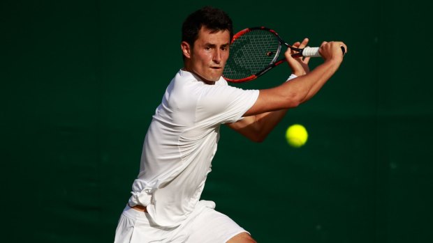 Bernard Tomic plays a backhand during his winning match against Roberto Bautista Agut.