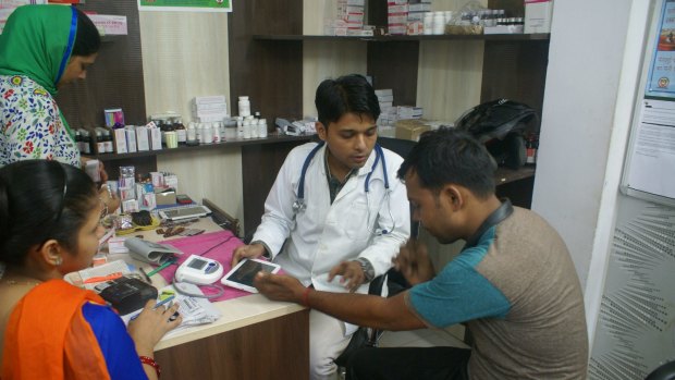Patient explains his symptoms to Dr Shoebul Haque. 