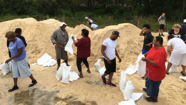People fill sandbags to prepare for Hurricane Nate in Mississippi.