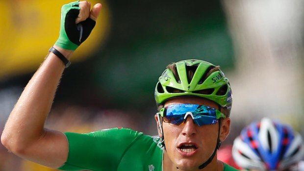 Germany's Marcel Kittel, wearing the best sprinter's green jersey, crosses the finish line to win the eleventh stage.