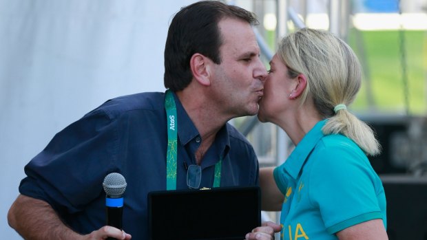 Rio de Janeiro Mayor Eduardo Pae, left, hands the key to the city to Australian delegation head Kitty Chiller during a ceremony at the Olympic Village on Wednesday.