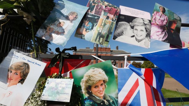 Pictures and flags hanging on the gates of Kensington Palace.