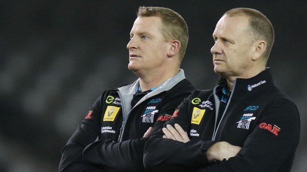Not impressed: Port Adelaide head coach Ken Hinkley and assistant Michael Voss lament Port’s 64-point humiliating loss to the Bulldogs on Saturday. 