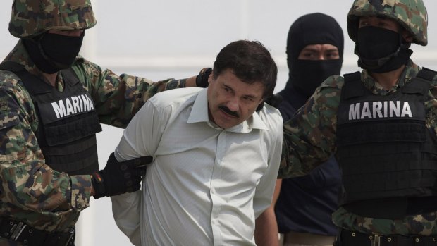 Guzman is escorted to a helicopter in handcuffs after being captured in Mexico City in February 2014. 