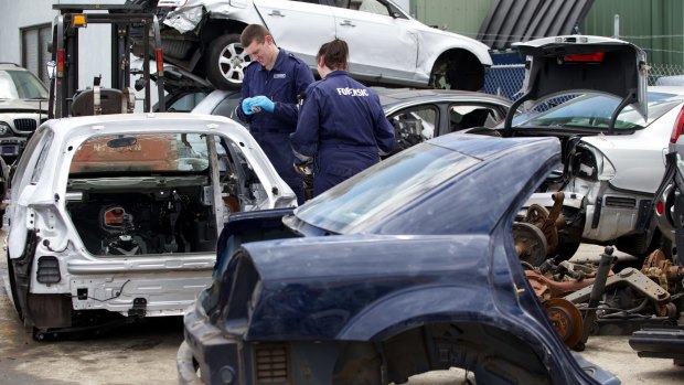 Vehicle Crime Squad detectives at a Melbourne factory where allegedly stolen luxury vehicles have been uncovered.