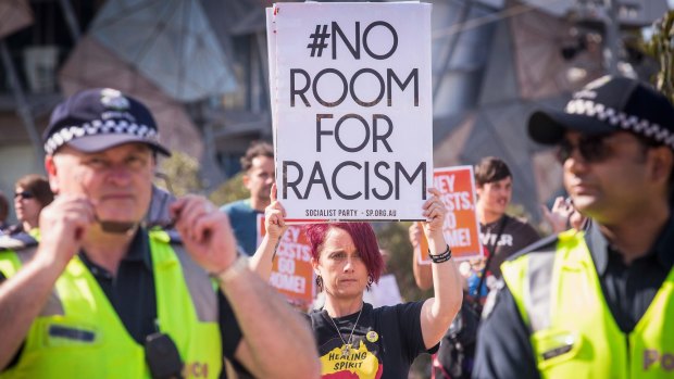 Police stand guard at Federation Square as warring protest groups clash.