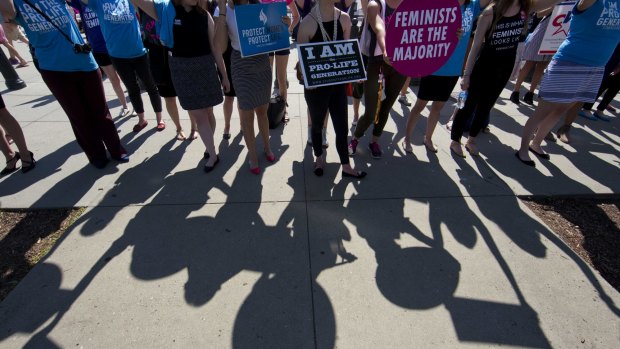 Demonstrators on both sides of the abortion issue stand in front of the Supreme Court in Washington in June.