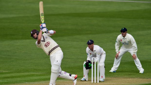 Kevin Pietersen drives a ball to the boundary as Glamorgan captain Jaques Rudolph (right) and wicketkeeper Mark Wallace watch.
