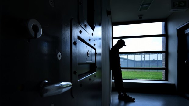 An inmate stands stands outside the rooms inside Cobham Juvenile Justice Centre, the principle remand centre in NSW for males aged 15 years and over. 