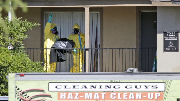 Infection risk: A hazardous material crew works at the apartment where Thomas Eric Duncan stayed in Dallas.