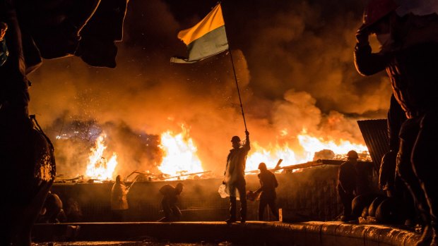 Anti-government protesters guard the perimeter of Independence Square on February 19, 2014.