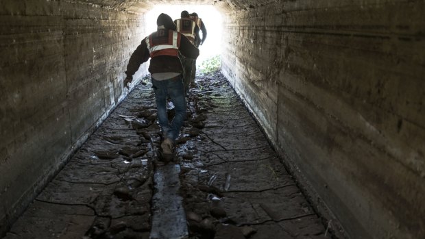 Workers pass through a tunnel at a construction site in Israel that employs illegal labourers among its Palestinian workers. 